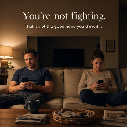 A couple on a sofa at night on their phones, not touching